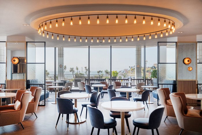 A restaurant area in a hotel with a view of the sea
